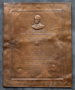 A plaque with an image of a man in bronze.
