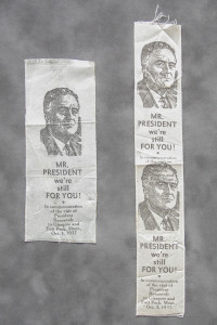 A couple of old paper banners with pictures of men.