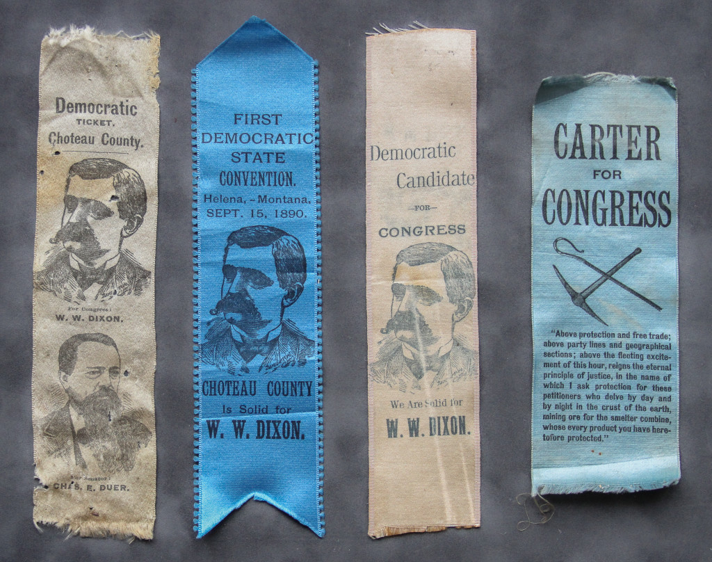 A close up of four ribbons with political posters