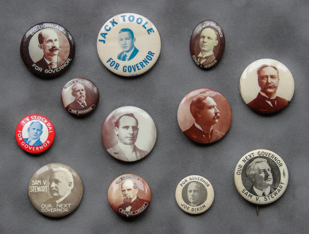 A bunch of political buttons are on the wall