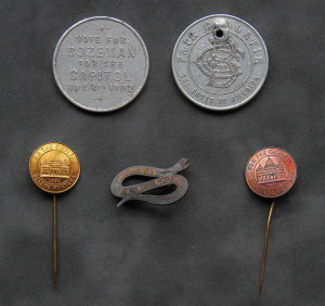 A close up of some old coins and pins