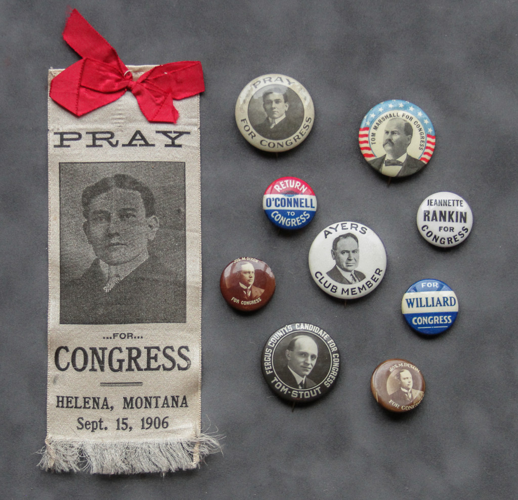 A bunch of political buttons and a ribbon