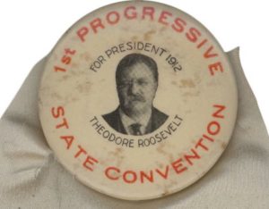 A button with an image of theodore roosevelt on it.