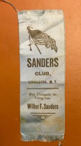 A close up of the sanders club ribbon